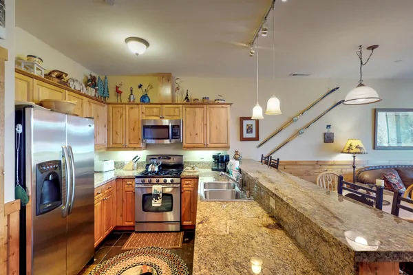 Kitchen with countertops~ oven and fridge: Truckee Cinnabar Vacation Retreat