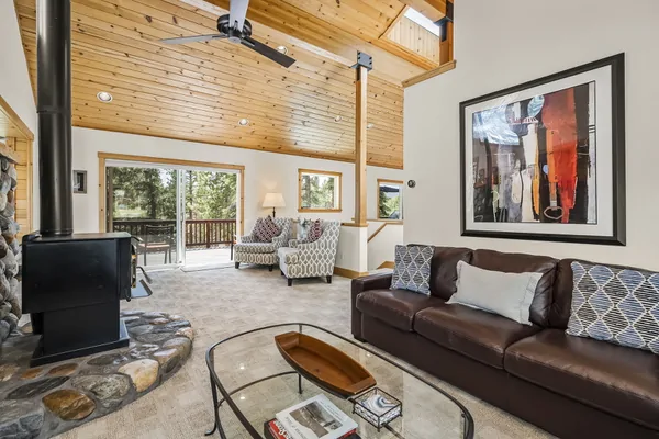 Living Room with wood-burning fireplace, and rustic river-rock hearth