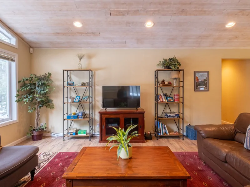 Living Room w/ Entertainment Center: Three Pines Family Cabin