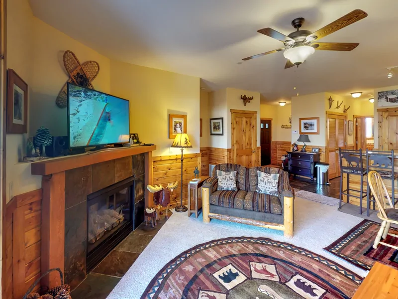 Living room with nearby kitchen and door to deck and nearby kitchen: Truckee Cinnabar Vacation Retreat
