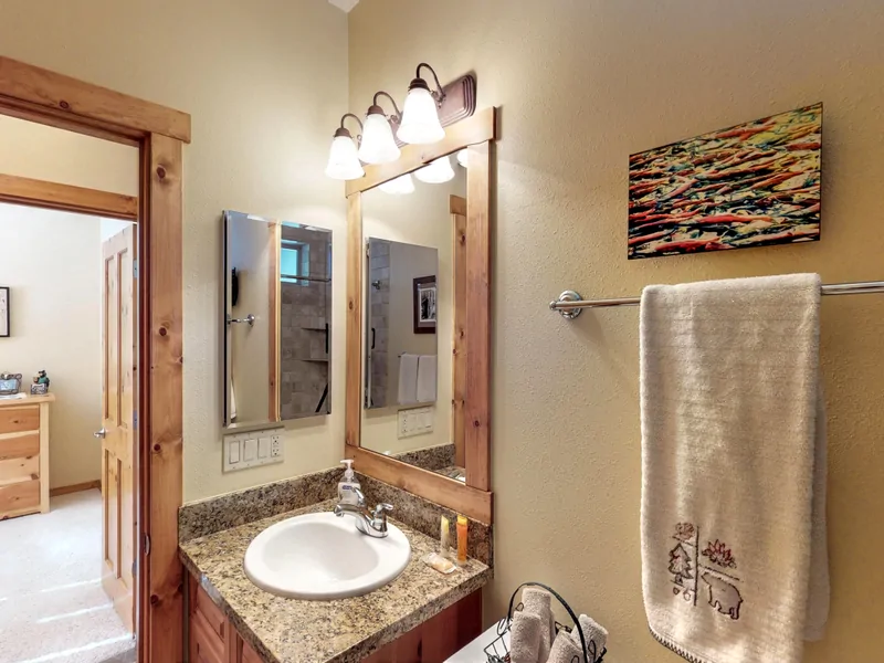 Bathroom with tan walls and sink: Truckee Cinnabar Vacation Retreat