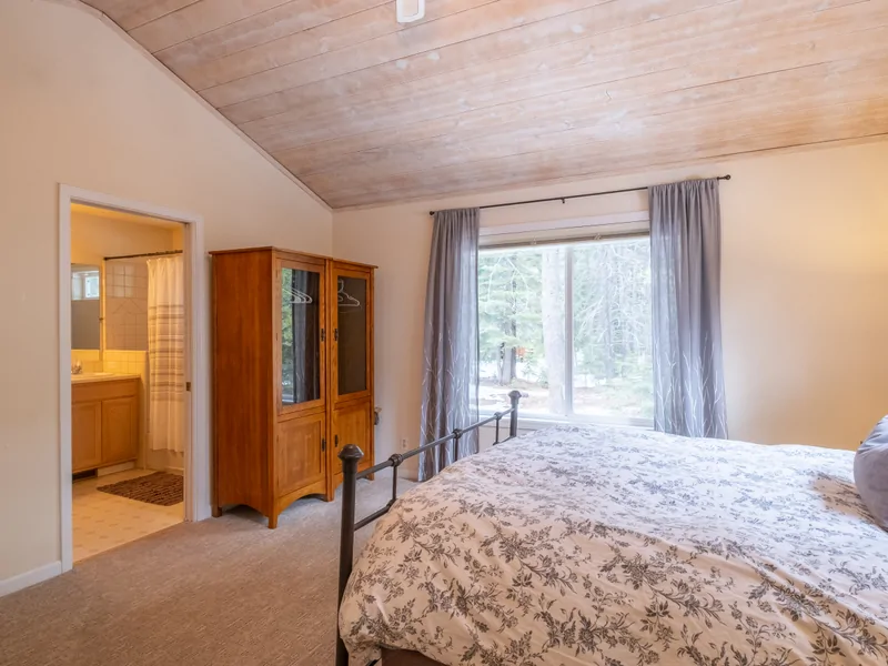 Primary Bedroom into Primary Bathroom: Three Pines Family Cabin
