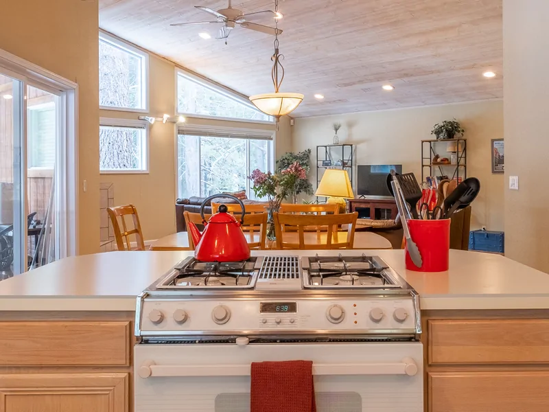Kitchen Stovetop into Dining Room: Three Pines Family Cabin
