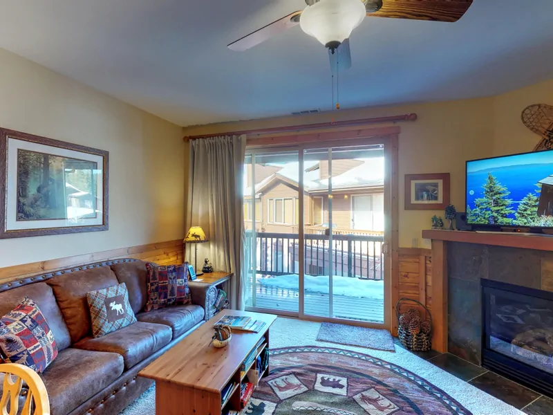 Living room with nearby kitchen and door to deck: Truckee Cinnabar Vacation Retreat