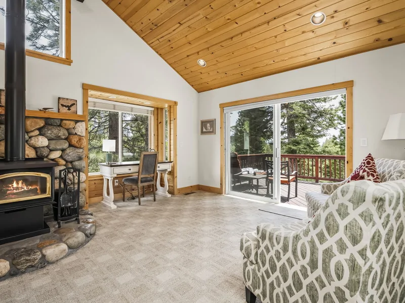 Living Room with wood-burning fireplace, and rustic river-rock hearth