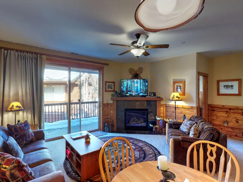 Living room with nearby kitchen and door to deck: Truckee Cinnabar Vacation Retreat